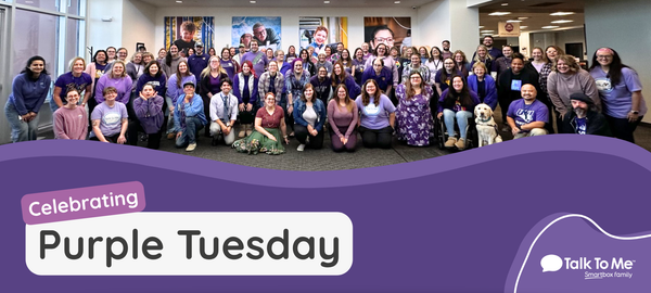 Group of people celebrating Purple Tuesday, wearing purple attire.